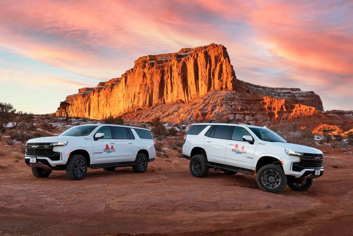 a car parked on the side of a dirt road