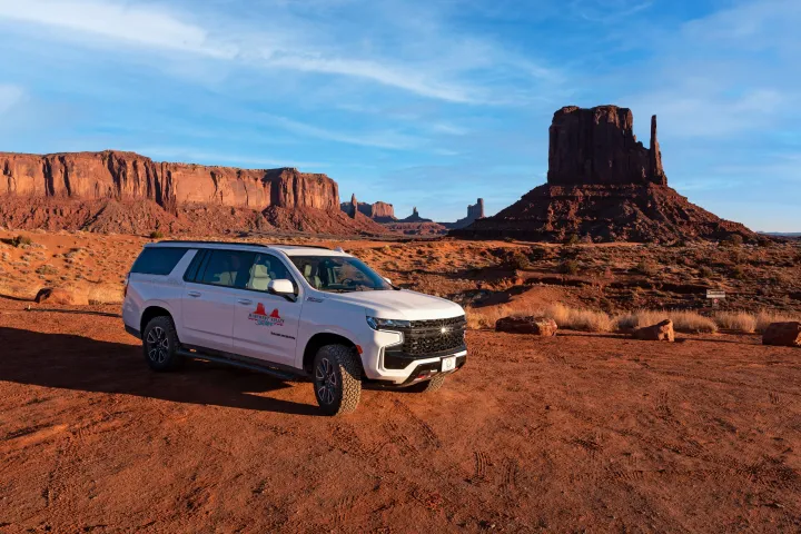 a car parked on the side of a dirt road